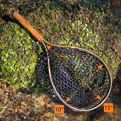 A bamboo fly fishing net lying on a rock in the water on the river in Western North Carolina. The rubber net basket is smooth and shiny and protects the fish for catch and release. The handle is flame cured for strength and durability and there is copper stitching and a copper keeper ring to attach your net keeper to.